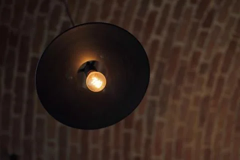 Round hanging lamp on brick ceiling Stock Photos
