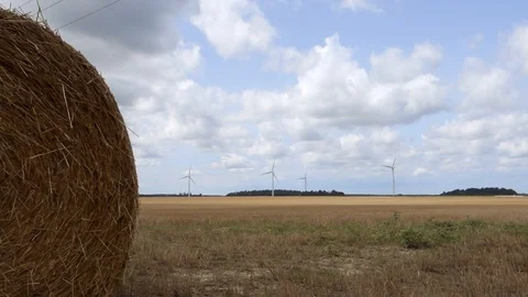 Round Hay Bale And Wind Turbines In Rural Ontario Canada 動画素材 93368166