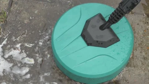 Round high-pressure washer spraying foaming water on cement tiles Video stock 305197827