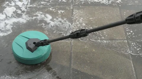 Round high-pressure washer spraying foaming water on cement tiles Video stock 305197863
