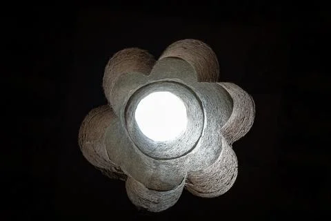 Round hole or window in the shape of a flower in a ceiling. Darkness and light Stock Photos