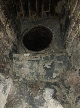 Round hole in the underground drenage system. Hole in the labyrinth Stock Photos