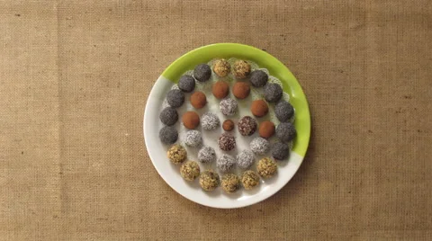 Round home made sweets appears on a plate. Stop motion animation Stock Footage 65881757