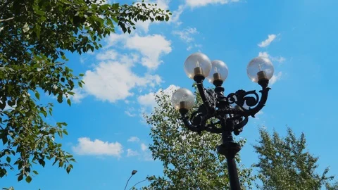 Round lanterns in the park against the background of the day sky Video stock 114830807