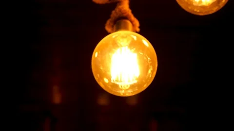 Round light bulb against a dark background Stock Footage 94144538