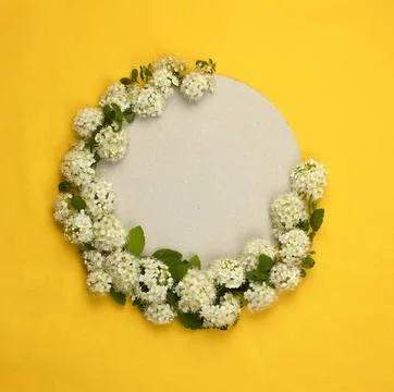 A round light frame of paper on a bright yellow background. Stock Photos
