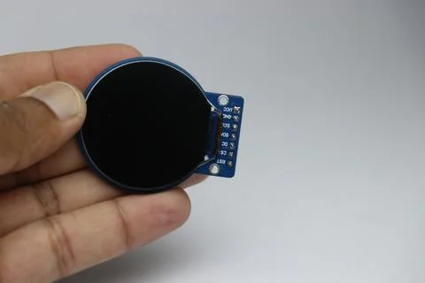 Round liquid crystal display module or known as LCD module held in the hand Stock Photos