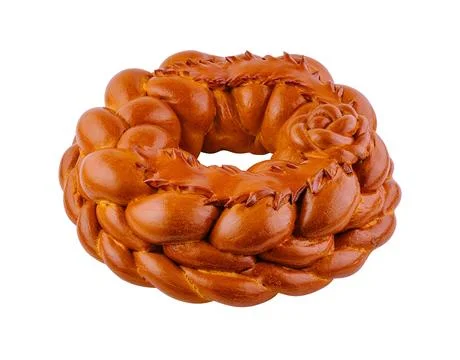 Round loaf of bread decorated with dough flowers baking on white background 스톡 사진