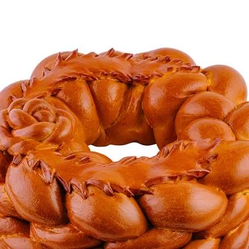 Round loaf of bread decorated with dough flowers baking on white background 스톡 사진