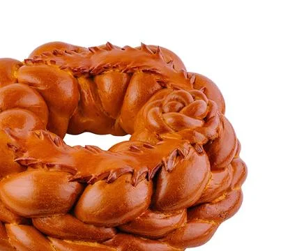 Round loaf of bread decorated with dough flowers baking on white background 스톡 사진