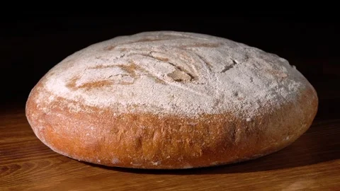 A round loaf of bread sprinkled with flour. Stock Footage 165819300