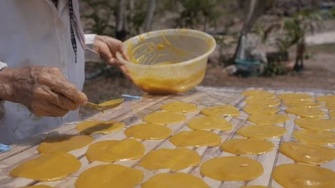 Round Mango Paste Drying on the Sun for making Dried Mango Paste Roll Stock Footage 122430156