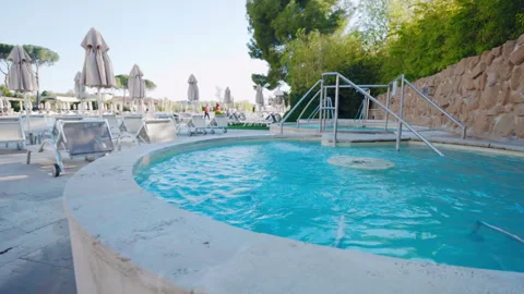 Round marble jacuzzi pool with turquoise water on the backyard of luxury spa Stock Footage 264769251