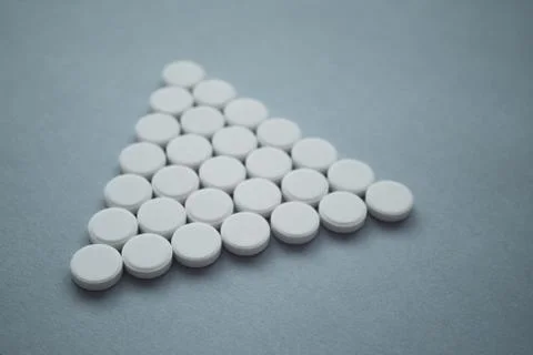 Round medicinal pills in the shape of triangle Stock Photos