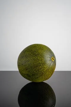 Round melons on a light background, beautiful texture, autumn harvest time Stock Photos