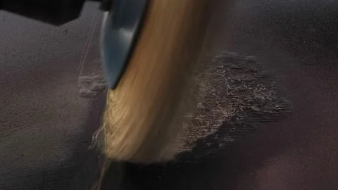 A round metal brush in the hands of a worker polishes paint on a car door 库存影片 211438011
