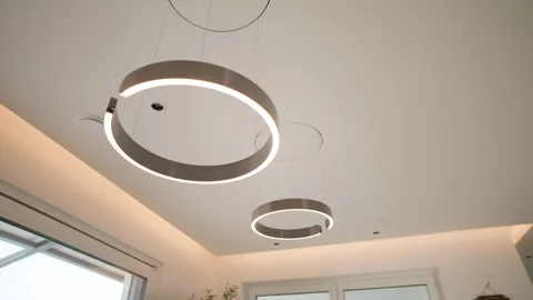 Round Metal Ring Pendant Lights on White Ceiling, Modern Interior, Panning Shot Stock Footage 341567746
