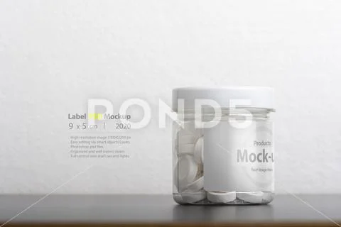 Round mint pills inside plastic bottle in front of white background mock-up s PSD Template