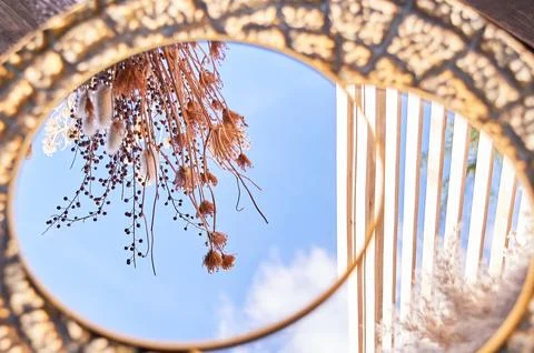 Round mirror in a golden frame. With the reflection of the sky. Beauty is in the Stock Photos