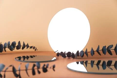 Round mirror on a neutral background among the eucalyptus Stock Photos