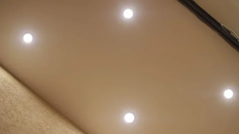 Round modern ceiling lamp in minimalist interior with hidden LED backlight. Stock Footage 256439989