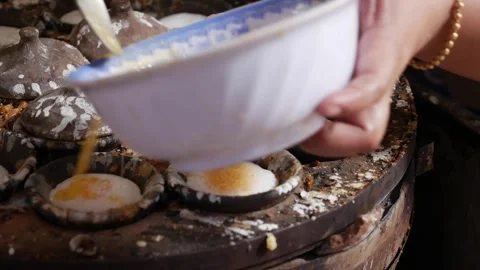 Round molds filled with white batter cook on a work table during preparation of 스톡 동영상 342139983