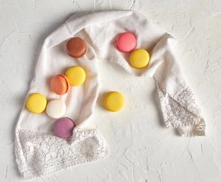 Round multi-colored baked macarons with cream on a white towel Stock Photos