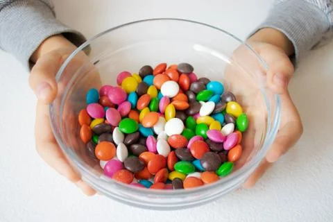 Round, multi-colored candies. Candy close-up, in a glass container. Stock Photos