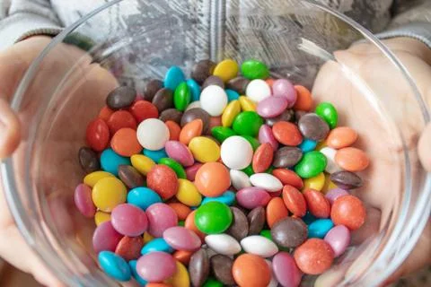 Round, multi-colored candies. Candy close-up, in a glass container. Stock Photos