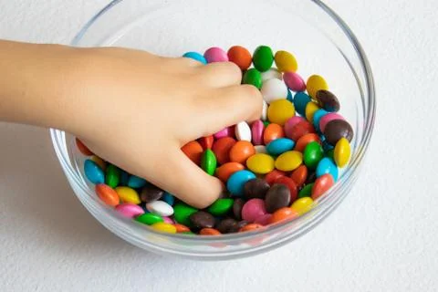 Round, multi-colored candies. Candy close-up, in a glass container. Stock Photos