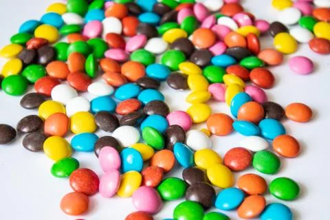 Round, multi-colored candies. Candy closeup on a white background. Stock Photos