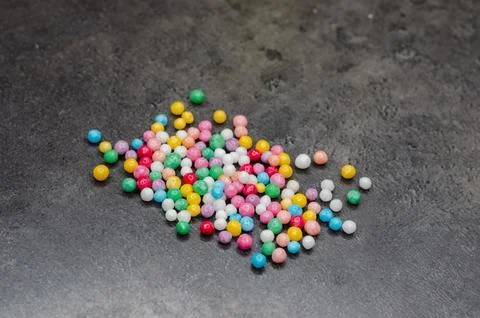 Round, multi-colored candies. Candy closeup on a white background. Stock Photos