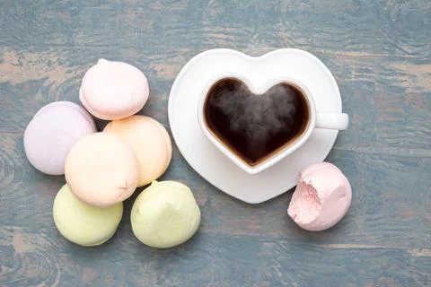 Round multi-colored marshmallows in a pile, a bitten off half of a marshmallo Stock Photos