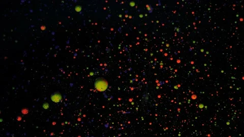 Round multicolored balls on a black background with silver sequins. Red, blue Stock Footage 171185077