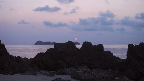 Round orange sun circle on the sunset in the rock beach. Stock Footage 107865671