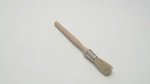 A round paint brush rotates on a white background. Stock Footage 268985170