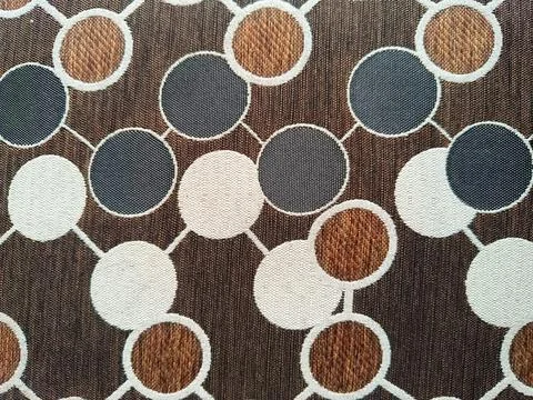 Round patterned sofa fabric texture. Stock Photos