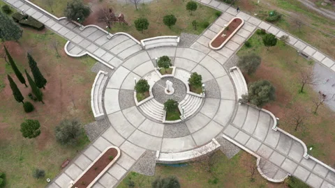 Round paved podium, surrounded by grass, as the central square of green park Stock Footage 151870383