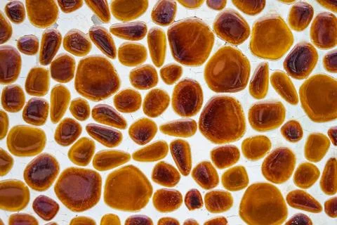 Round pebbles on a white surface. Stock Photos