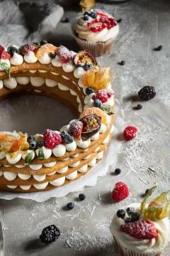 Round pie with berries on a gray background Stock Photos