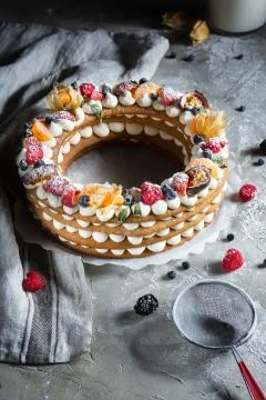 Round pie with berries on a gray background Stock Photos