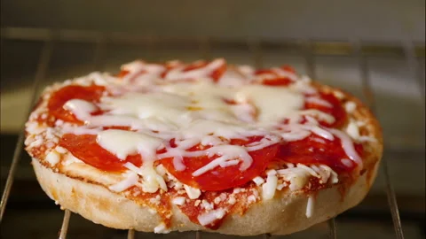 Round pizza time lapse in hot oven melting cheese bubbling Stock Footage 150919184