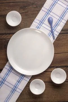 Round plate and empty round tea cups on towel 스톡 사진
