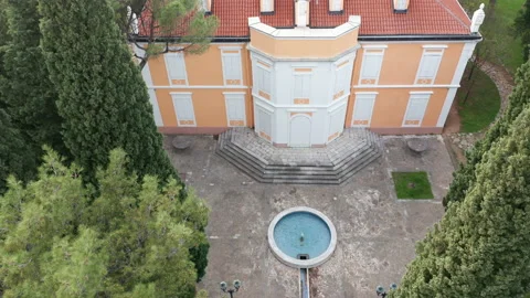 Round pool in front of a historical mansion house surrounded by tall trees Stock Footage 152182236