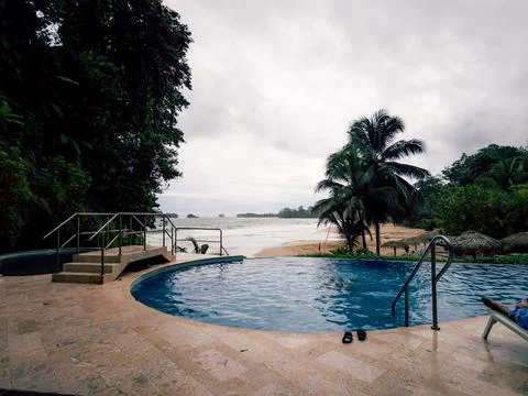 Round pool reflects the overcast sky Fotos de archivo