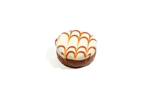 Round praline with a mesh pattern on a white background. Stock Photos