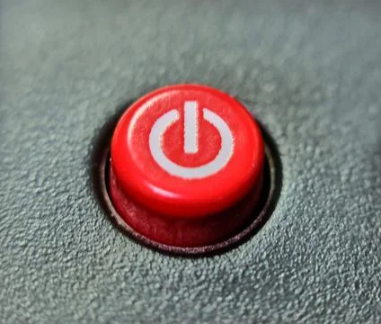Round red on/off button on black background Stock Photos