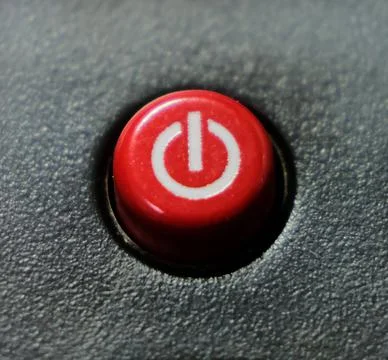 Round red on/off button on black background Stock Photos