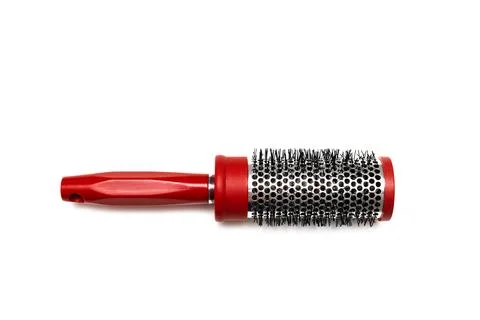 Round red comb on a white background. Stock Photos