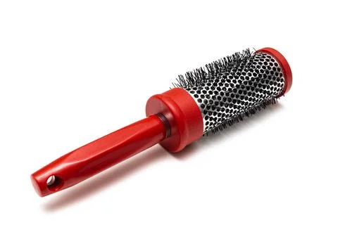 Round red comb on a white background. Stock Photos